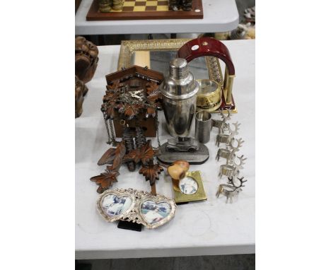 A WOODEN CUCKOO CLOCK WITH WEIGHTS, A FOX &amp; SIMPSON BATTERY OPERATE CLOCK, FIVE STAG NAPKIN HOLDERS, A DECORATIVE GILT FR
