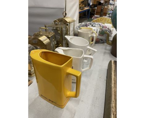 A COLLECTION OF FIVE WATER JUGS TO INCLUDE FOUR WADE AND ONE BURLEIGH WARE