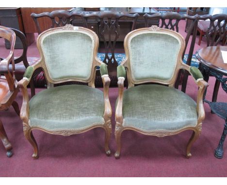 Pair of French Style Armchairs, with carved top rails, upholstered back panel, arms, seats, carved serpentine front rails, on