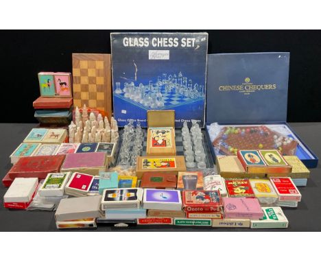 A glass chess set and board, by Harrogate House, boxed; a carved soapstone chess set; wooden Staunton type chess sets; a coll