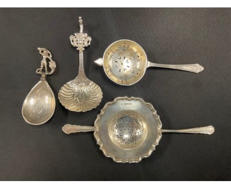 An Edwardian silver caddy spoon, George and Dragon finial, London 1902; a silver tea strainer, Deakin &amp; Francis, Birmingh