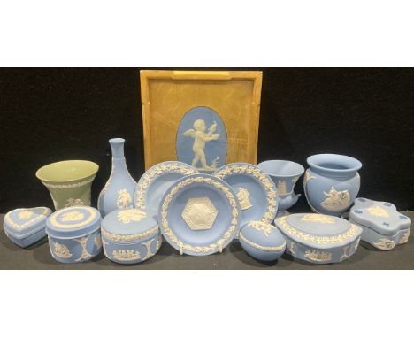 A Wedgwood oval wall plaque, pale blue Jasper, with a cherub and dove in relief, 12.5cm, impressed mark, giltwood mount and f