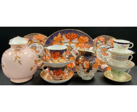A pair of late 19th century Royal Crown Derby 2444 Imari pattern breakfast trios, date cypher for 1897; a similar milk jug an