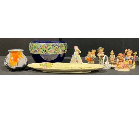 A Royal Doulton figure, Babie, HN1679, printed mark in green, mid-20th century; a Doulton style tube lined jardinière; Goebel