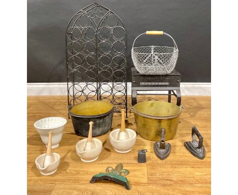 A 19th century iron footman, 33cm high; a brass jam pan; another; pestles and mortars; a large wire trug; stoneware jelly mou