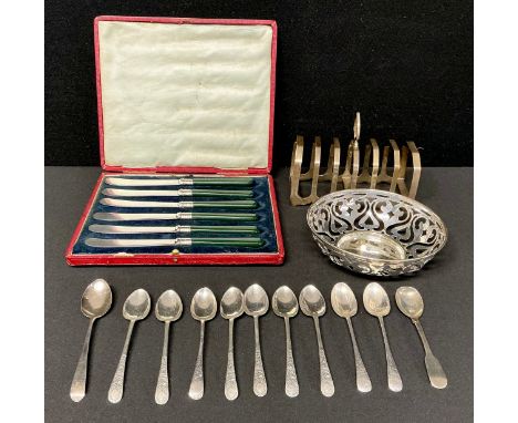 A George V silver seven bar toast rack, 14cm long, Sheffield 1934, 147g; a provincial silver condiment spoon, Matthew West, D