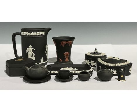 A Wedgwood Black Basalt miniature tea set, comprising teapot, sucrier and cover, milk jug, teacup, saucer and tea plate; a We