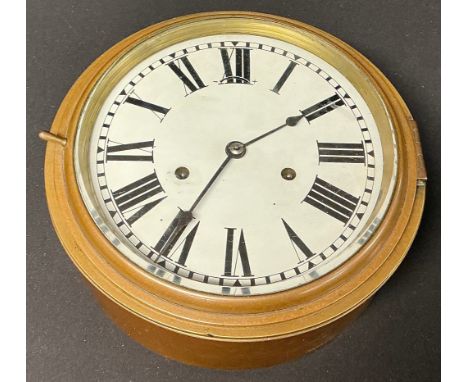 An early 20th century brass porthole wall clock, white enamel dial, Roman numerals, twin winding holes, hinged cover with bev