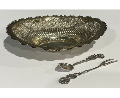 A Victorian silver oval dish, embossed with scrolls, 18cm, London 1894; a continental silver pickle fork and spoon, marked 83