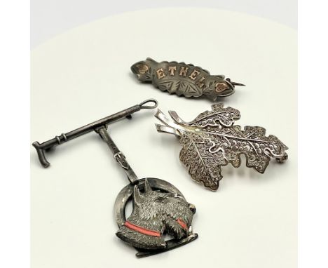 A Vintage Charles Horner Riding Crop Scottie Dog Bar Brooch and two silver brooches;the Charles Horner brooch is one of their