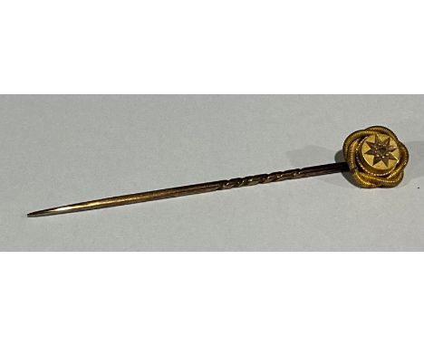 A late 19th century 15ct gold flower head stick pin, set with a single old cut diamond stone, marked 15ct, gold plated steel 