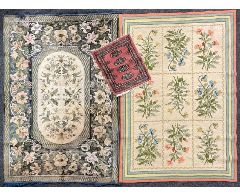 A Chinese silk rectangular rug or carpet, decorated with flowers, 187cm x 129cm; a woollen rectangular rug or carpet, worked 
