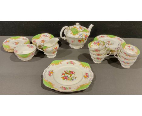 A Paragon Rockingham pattern tea service for six, comprising teapot, cake plate, side plates, cream jug, sugar basin, cups an