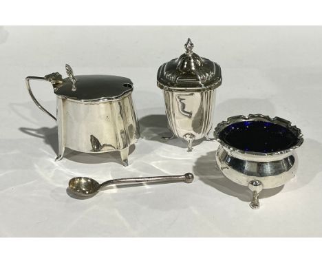 A George V silver mustard, blue glass liner, Birmingham 1913; a silver pepperette, Birmingham 1940; a silver salt, Birmingham