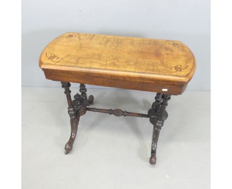 A Victorian walnut fold-over card table, with a selection of games. 90x73x44cm. 