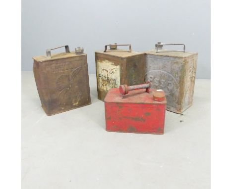 Four vintage oil cans, including Esso and Shell.