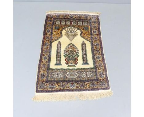 A silk cream-ground Persian prayer mat. 125x80cm. 