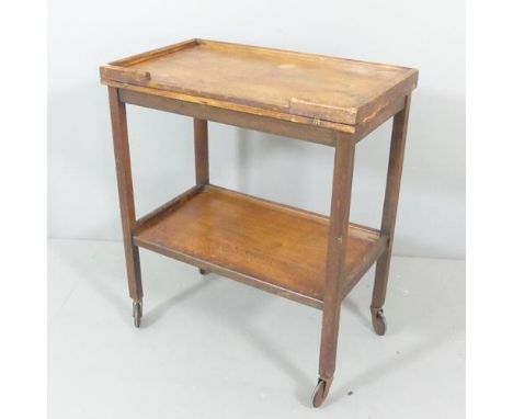 A 1920s oak "Chevin" two tier trolley with fold-over games top, with label.  68x78x40cm.Some water marks to wooden top. Green