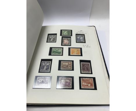 A blue leather stamp album containing a good commonwealth collection that is well presented. This includes many set up to one