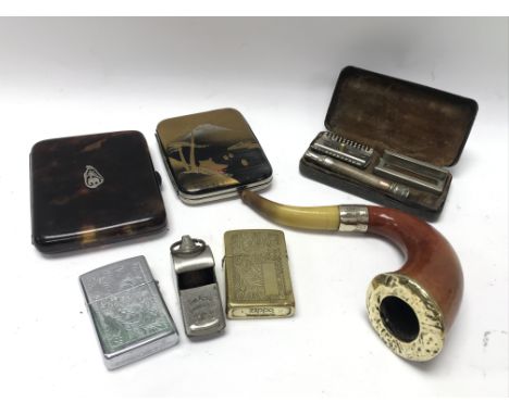 A large vintage Meerschaum pipe, 2 zippo lighters, 2 cigarette cases, a boxed razor and whistle.