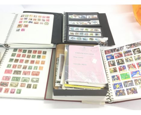 A collection of four stamp albums containing world used stamps a box of commonwealth presentation packs mainly Royal Commemor