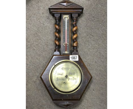 An oak cased barometer By Henry Hughes &amp; Sons with barley twist columns - NO RESERVE