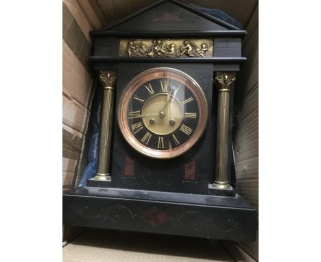 A Black marble mantle clock, the circular dial having Roman numerals, flanked by Corinthium columns - NO RESERVE