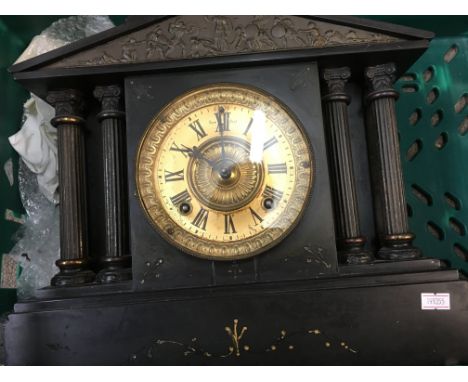 A Victorian slate mantle clock of classical form the circular dial with Roman numerals.