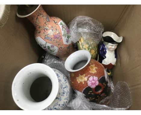 A box of ceramics comprising a converted table lamp, vases, Toby jug etc.