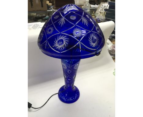 A blue glass table lamp, approx height 58cm.