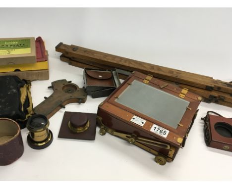 A Quality half plate Mahogany and brass folding vintage camera with two lenses numerous photo plates stand.