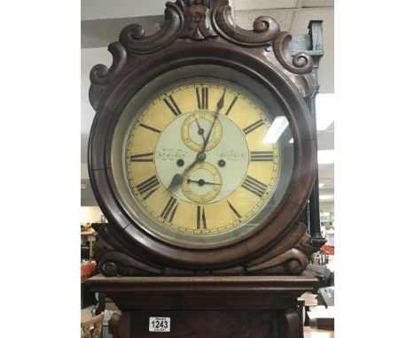 A walnut longcase regulator type 8 day clock the circular dial with Roman numerals seconds and date aperture with visible pen