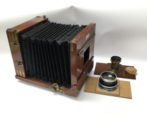 A large format plate camera, inset with plate for Sands, Hunter &amp; Co Ltd together with a brass mounted lens marked f8 to 