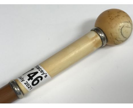 A Victorian walking stick with ivory handle and brass feral