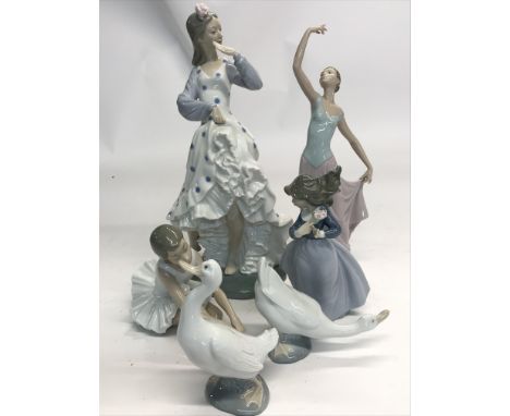 A collection of NAO by Lladro figures, including two geese, a flamenco dancer, two ballerinas and a smaller girl figure.