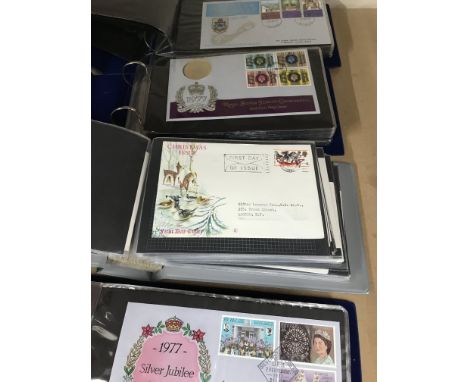 Four albums containing first day covers .