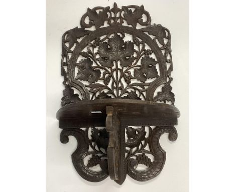 A carved wooden Blackforest style folding wall shelf. 45cm.