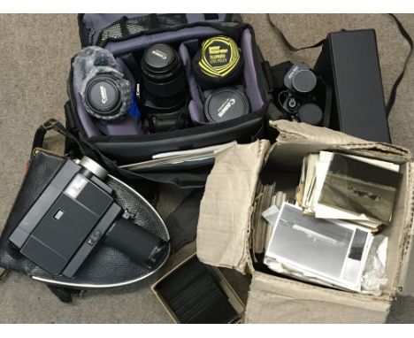 A collection of photographic cameras and accessories including a Canon EOS 450D with lenses including a 60mm macro and a 17-5