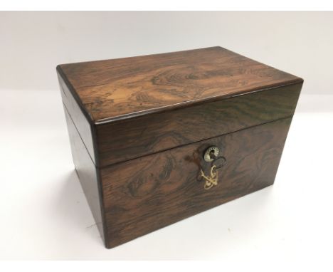 A rosewood tea caddy with glass mixing bowl and fitted tea canister to interior.