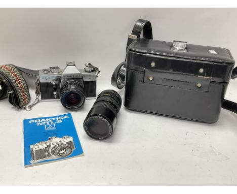 A vintage Praktica MTL3 camera with 29mm f2.8 pentacon lens and Helios 70-150mm f3.8 zoom lens in carry case with original in