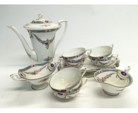 A Royal Worcester coffee service with handpainted decoration of floral swags on a white ground.