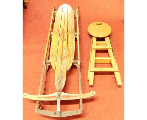 A vintage child's metal polychrome painted wooden topped sledge, 150cm, together with an oak folding stool (2)