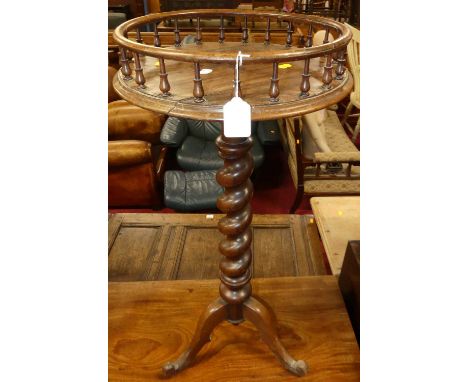 An early Victorian rosewood pedestal tripod table, the fixed top having a full spindle gallery, dia.37cm