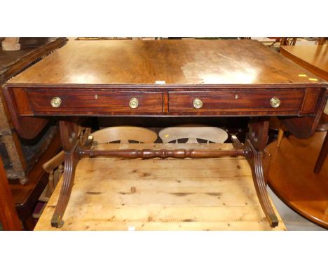 A 19th century mahogany sofa table, having twin frieze drawers, round fall leaves with reeded end detail, raised on lyre end 