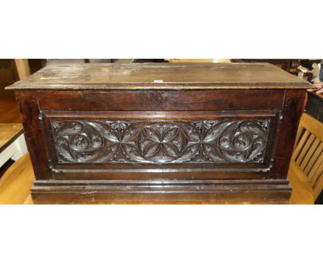 An antique joined oak and elm coffer the frieze carved with gothic tracery,width 110cm