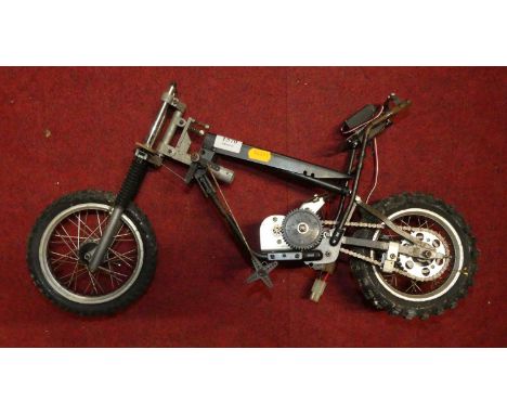 A part-complete battery operated motorcycle, approx 1:8 scale