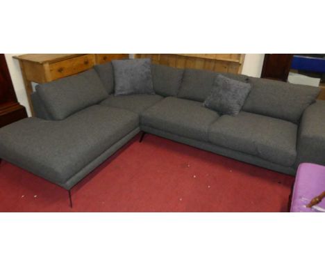 A contemporary modular corner sofa unit upholstered in charcoal grey with scatter cushions