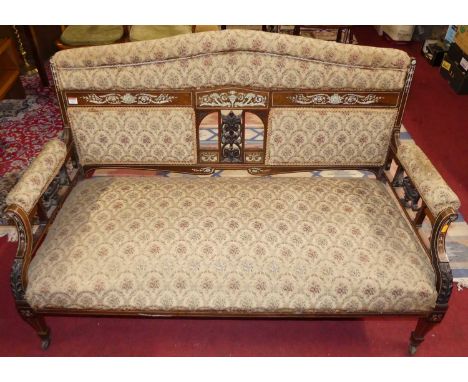 A late Victorian mahogany, rosewood and floral ivory inlaid two-seater salon sofa, having all-over floral needlework embroide