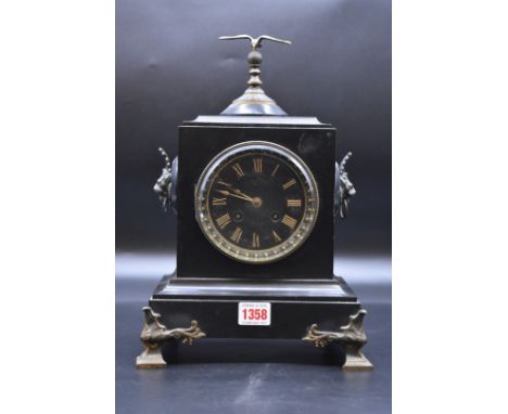 A late 19th century French slate and brass mantel clock, 33cm high.&nbsp; 