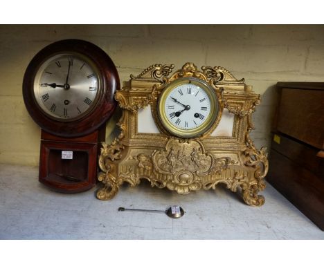 A gilt spelter mantel clock, 36cm wide, with pendulum; together with a small drop dial wall timepiece, 33cm high, with pendul